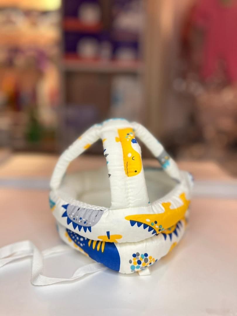 طاقية حماية الراس من الصدمات لون ابيض ديناصورات